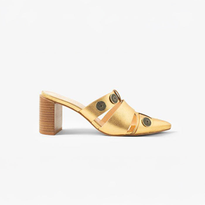 Gold heeled mules with cut-out straps and metal stud accents accents, featuring a stylish chunky wooden heel.