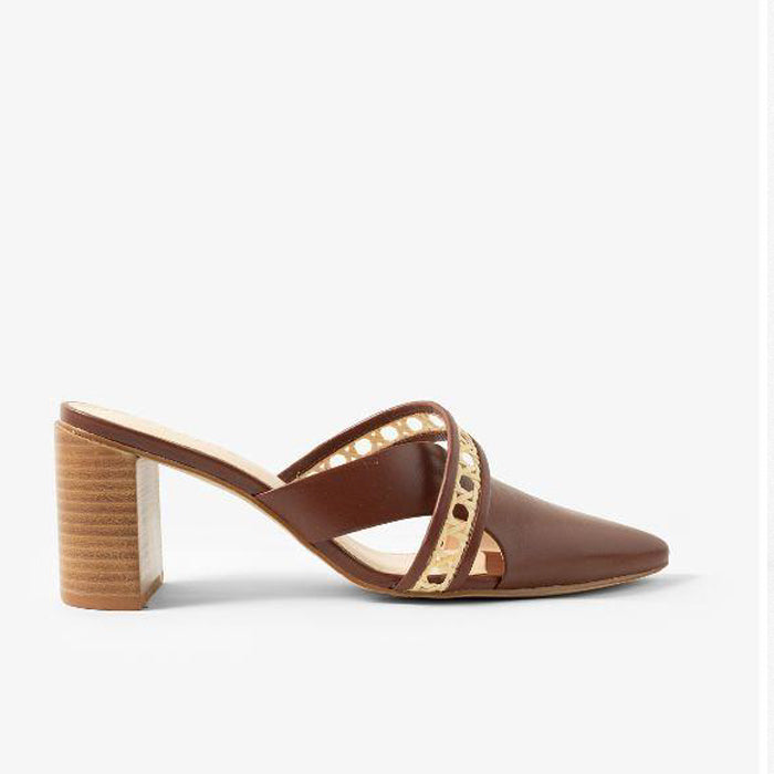 Brown heeled mules with a pointed toe and a straw weaved pattern, featuring a chunky wooden heel on a plain white background.
