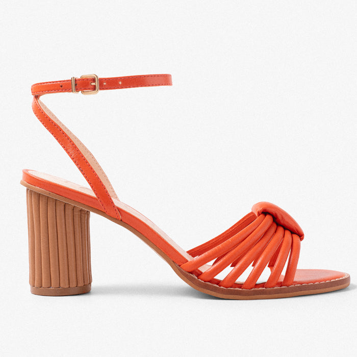 Bright orange heeled sandals with a stylish pleated design and ankle strap, featuring a chunky ribbed heel.