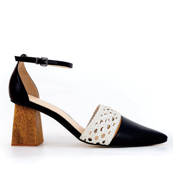 Black heeled sandal with a white woven strap and ankle buckle, showcasing a stylish design with a wooden block heel.