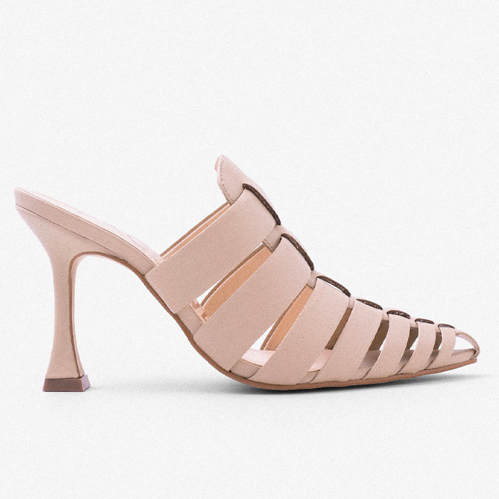 A stylish nude open-toe heeled sandal with elegant crisscross straps and a slender stiletto heel set against a solid white background